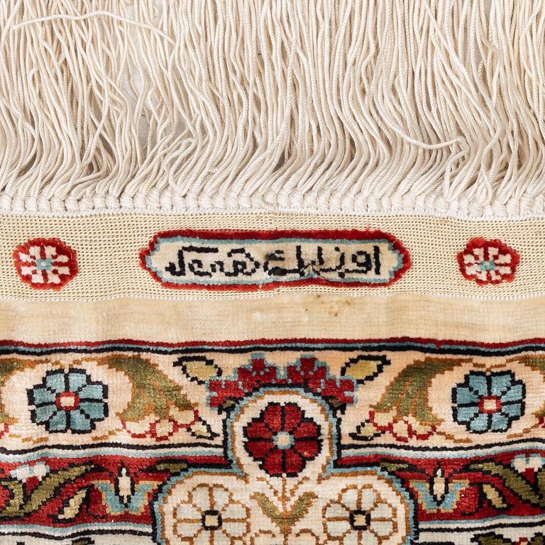 A semi-antique silk Hereke rug, West Anatolia, c. 180 x 121 cm.