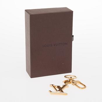 A Louis Vuitton bag charm.