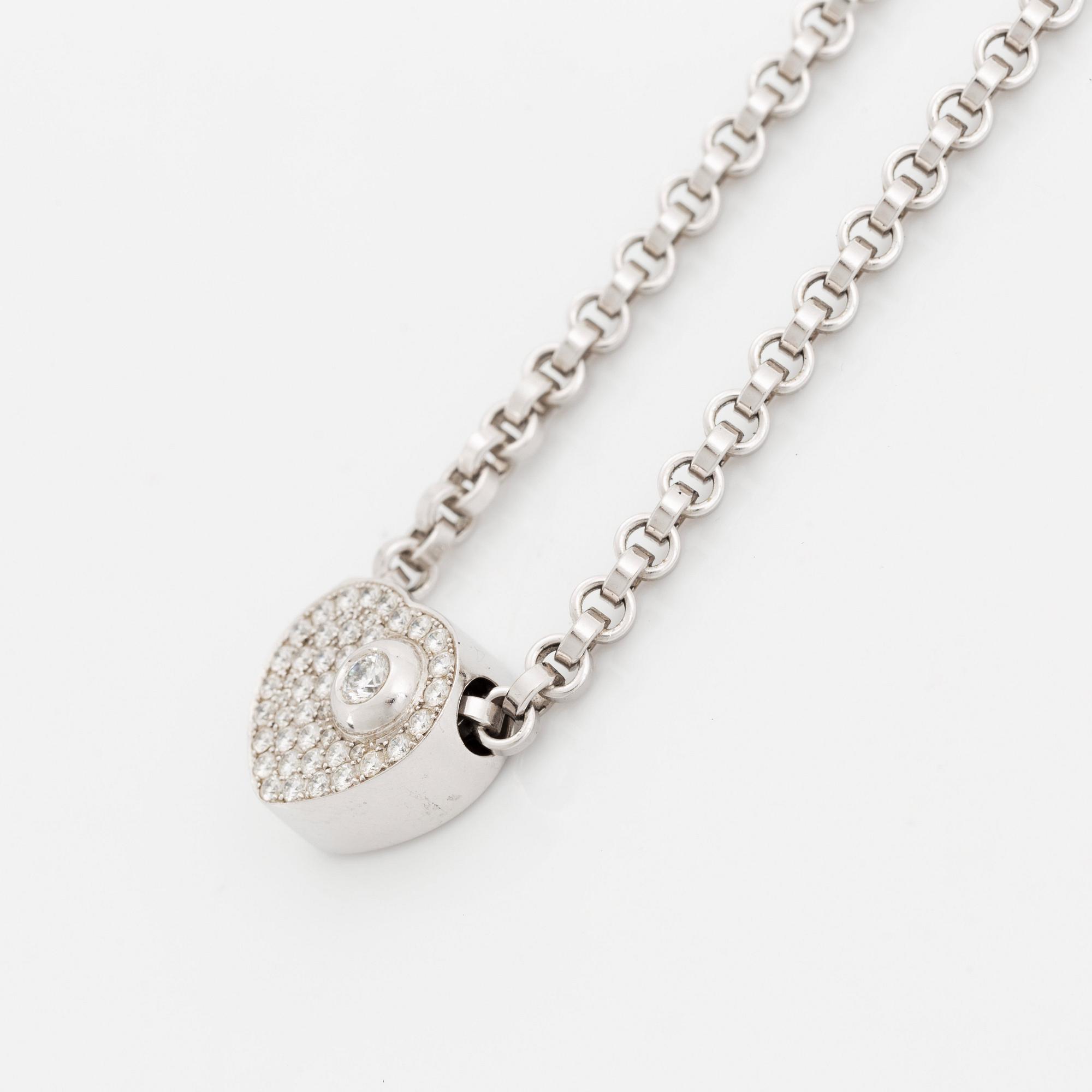 An 18K white gold Chopard "Happy Diamonds" necklace set with round brilliant-cut diamonds.