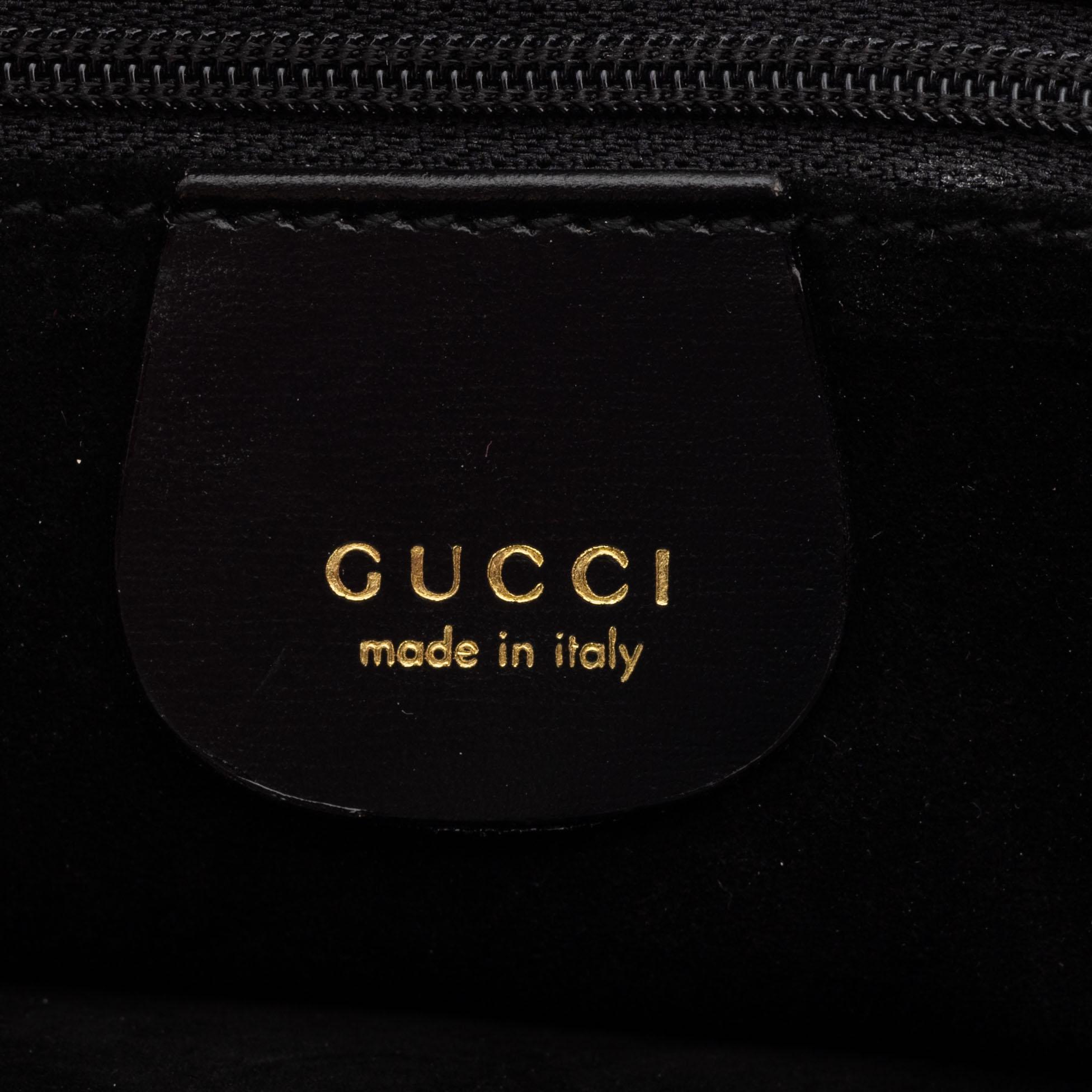 Gucci, a black suede handbag.