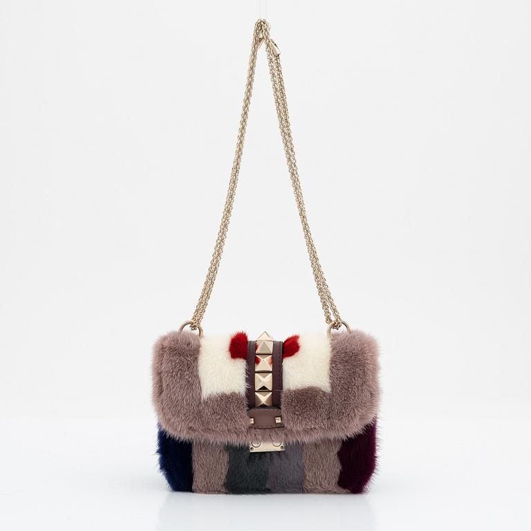 Valentino, a tinted fur, leather and studs bag.