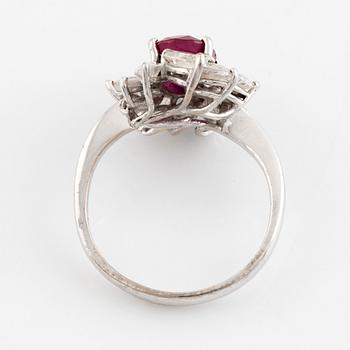 A ring set with a faceted ruby and navette-cut diamonds.