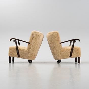 A pair of lounge chairs with new sheepskin upholstery, Denmark, 1930's/40's.