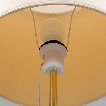 A brass floorlamp with a glass base, from 1970/80s.