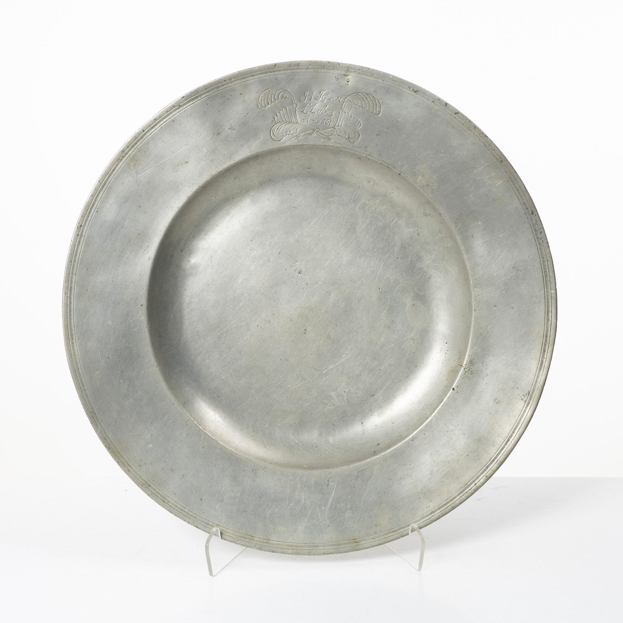 An English baroque pewter charger, dated 1672.