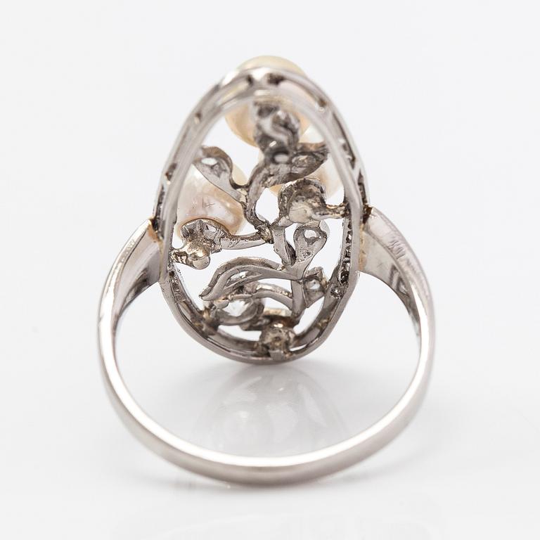 A platinum ring with old- and rose-cut diamonds and cultured pearls.