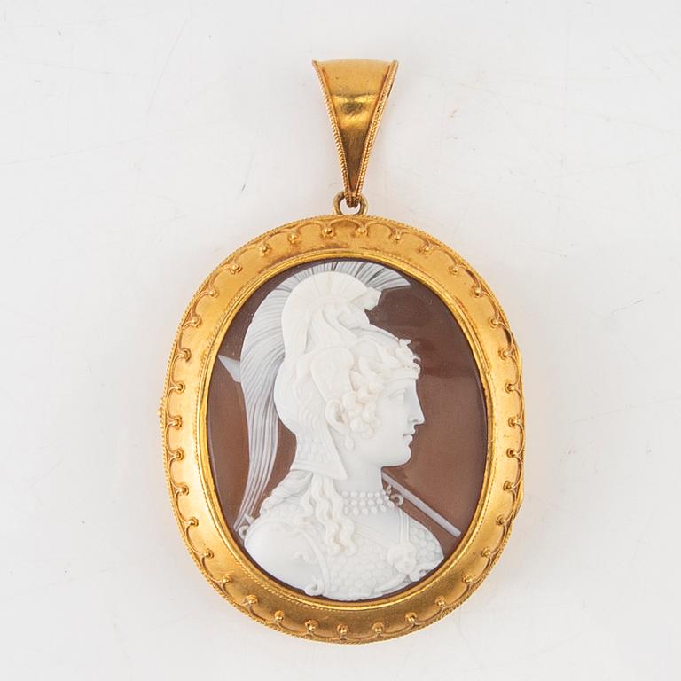 A 14K gold medallion with carved shell cameo.