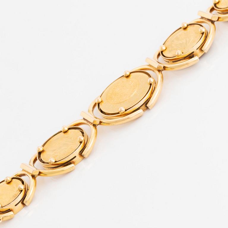 An 18K gold bracelet set with Mexican 22K gold coins.