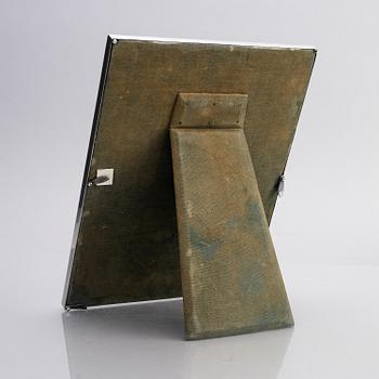 A silver and enamel frame with glass, mark of CG Hallberg, Stockholm 1935.