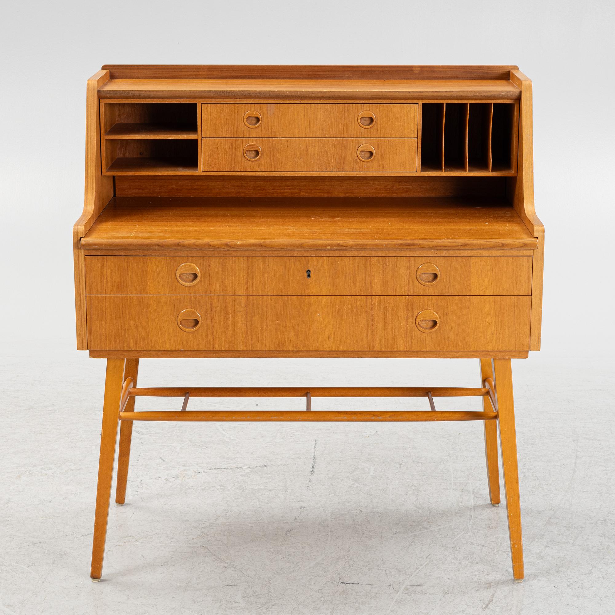 A teak-veneered desk, mid 20th century.