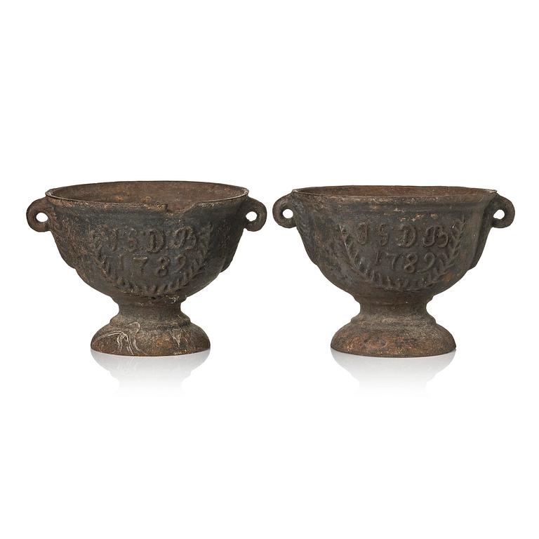 A pair of cast-iron garden urns, presumably from Näfveqvarns styckebruk, dated 1789.