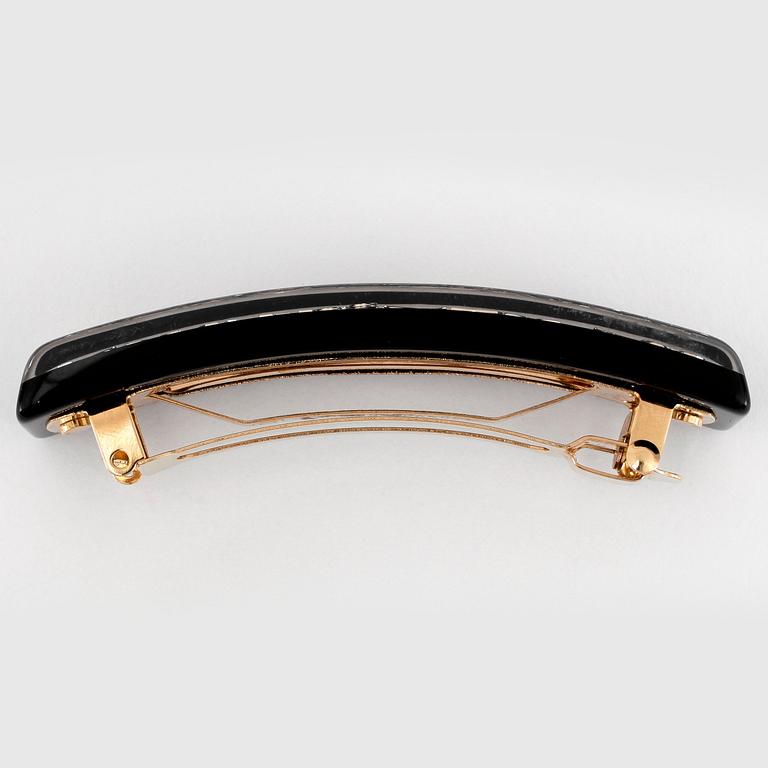 LOUIS VUITTON, a black acrylic and gold hair clip.