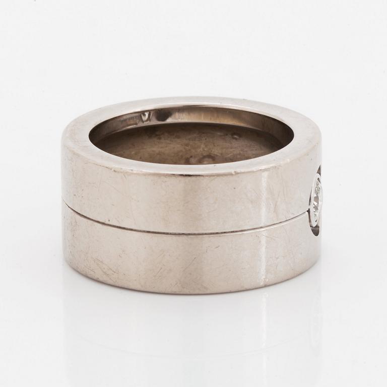 A Cartier 18K white gold ring set with a round brilliant-cut diamond.