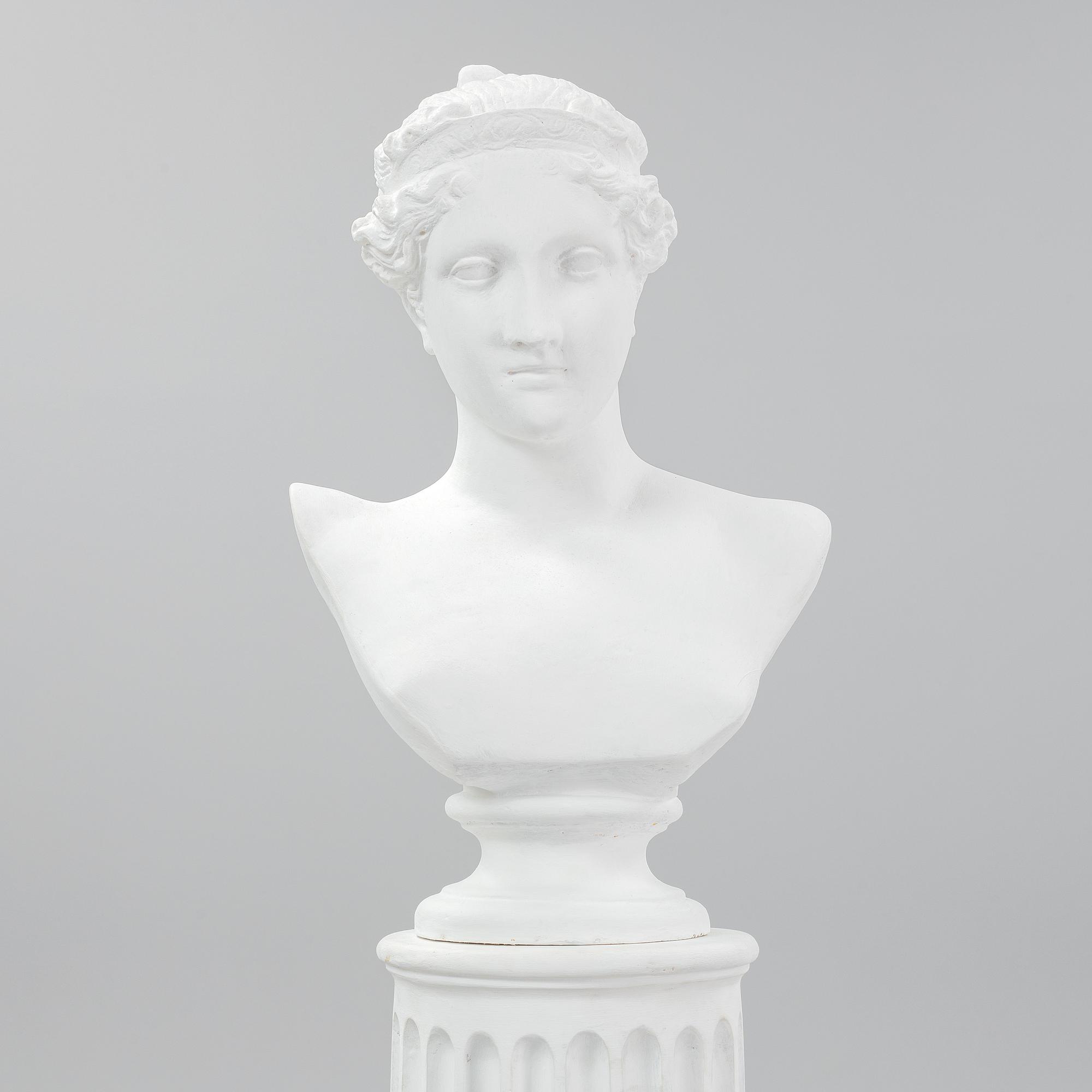 A plaster bust and pedestal.