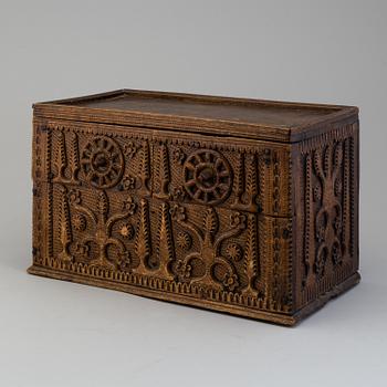 A 19th century wooden box with drawers.