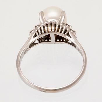 Ring in 900 platinum with a cultured pearl and round brilliant-cut diamonds.