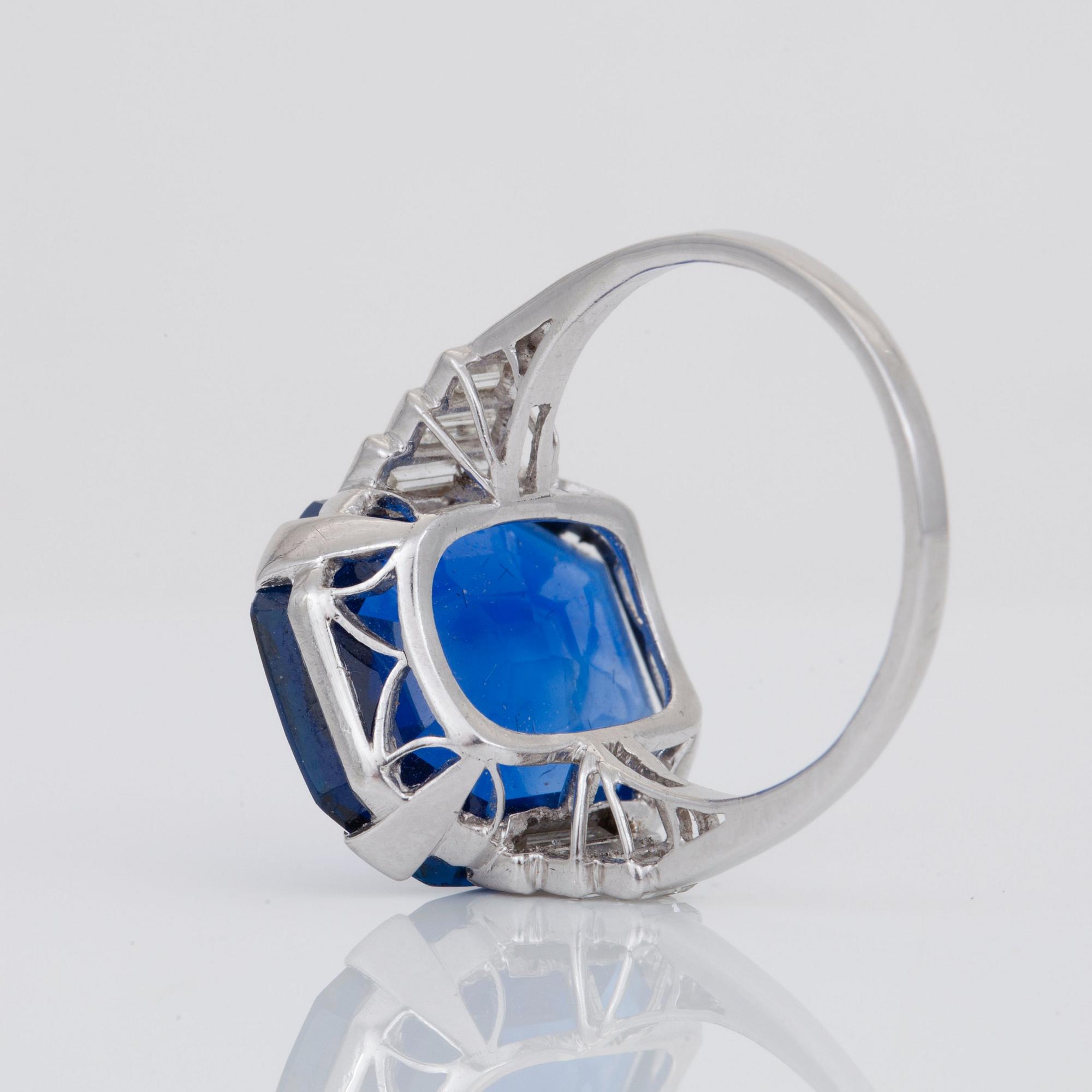 An unheated 11.27 ct Ceylon sapphire and baguette-cut diamond ring. Total carat weight of diamonds 0.70 cts.