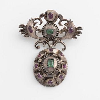Silver brooch with emeralds and rubies.