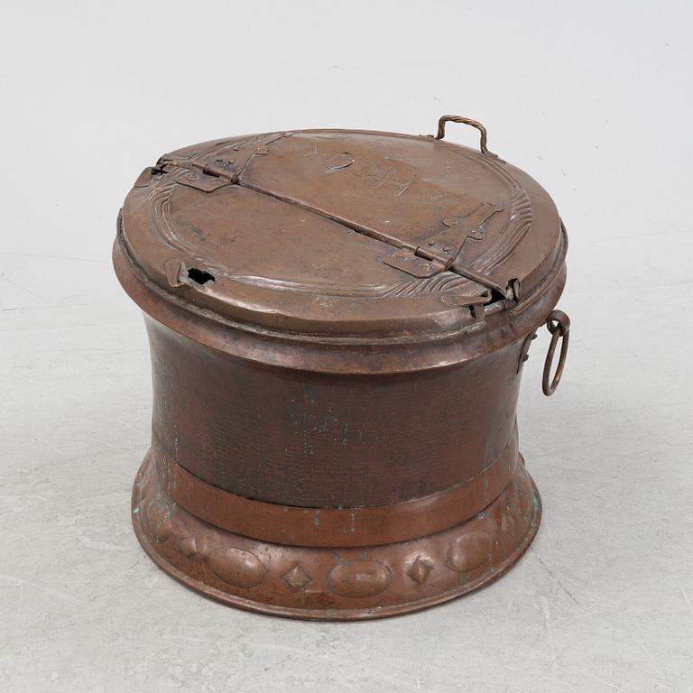 A copper water container, dated 1706.