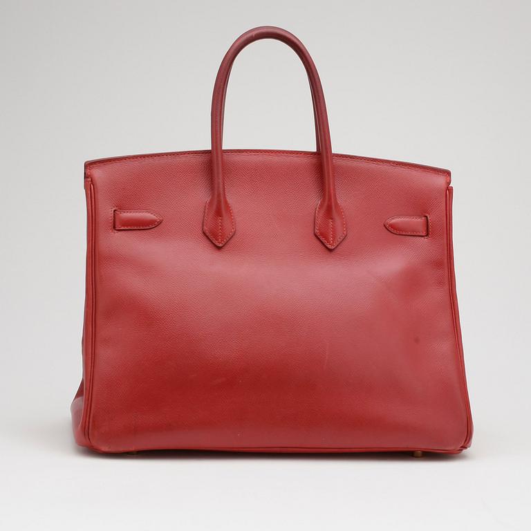 HERMÈS, a raspberry red leather "Birkin 35" bag.