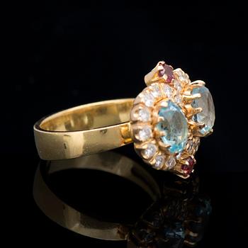 A RING, facetted topazes and garnets, brilliant cut diamonds, 18K gold. Kari Hirvonen, Helsinki Finland 1998.