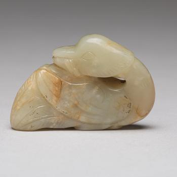 A Chinese nephrite figure of a duck with a lotus bud.