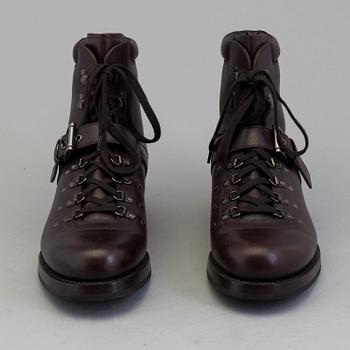 A pair of darkbrown leather boots by Prada.