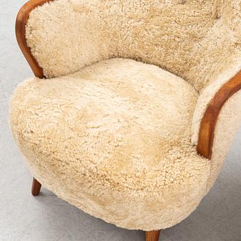 A pair of teak and sheepskin Swedish Modern 1950's easychairs.