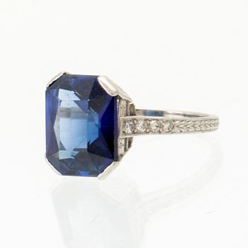 A Shreve & Co Platinum Ring set with a Synthetic Sapphire and Round Brilliant Cut Diamonds.