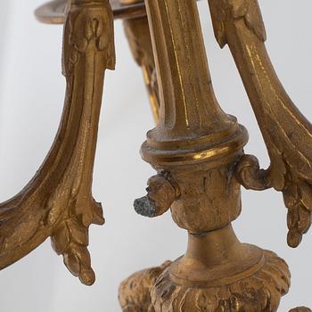 A pair of candelabras and a mantel clock, late 19th Century.