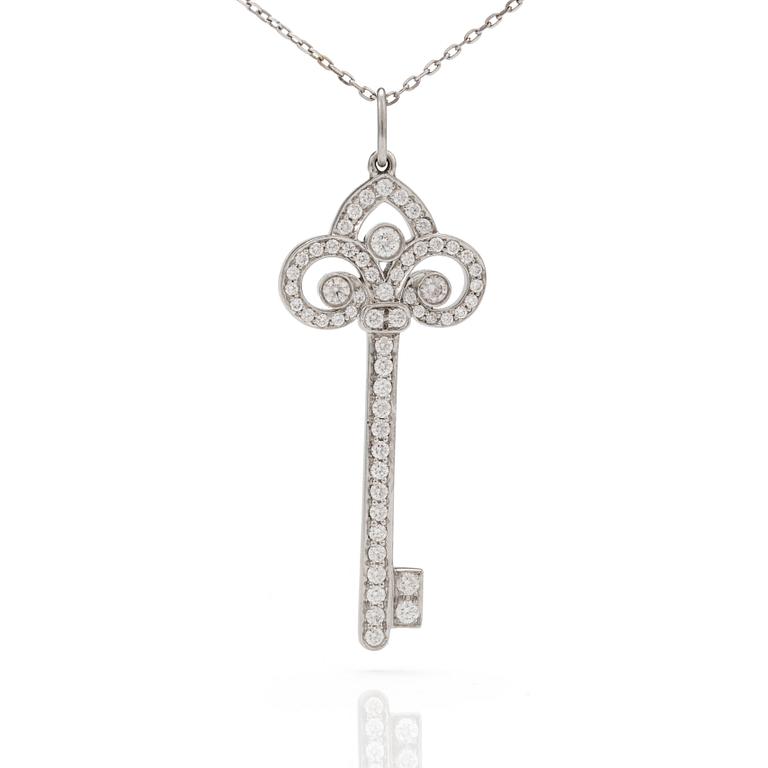 A 'Fleur de lis key' pendant set with round, brilliant-cut diamonds by Tiffany together with a chain.