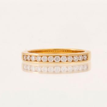 An 18K gold half-eternity ring set with round brilliant-cut diamonds.