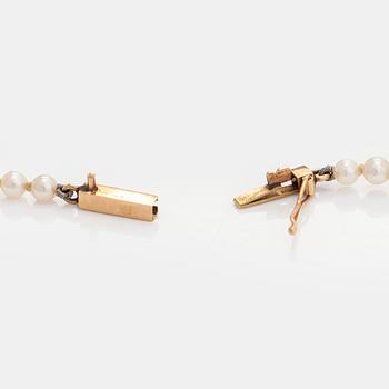 A graduated cultured pearl necklace, clasp in 14K gold.