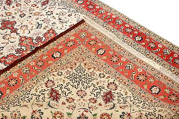A Tabriz, part silk carpet, c. 300 x 199 cm.