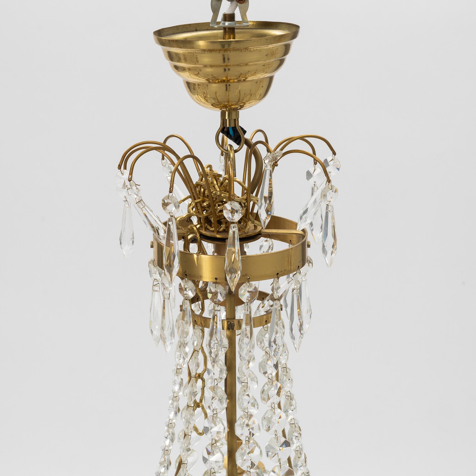 A contemporary matched pair of chandeliers for four candles each.