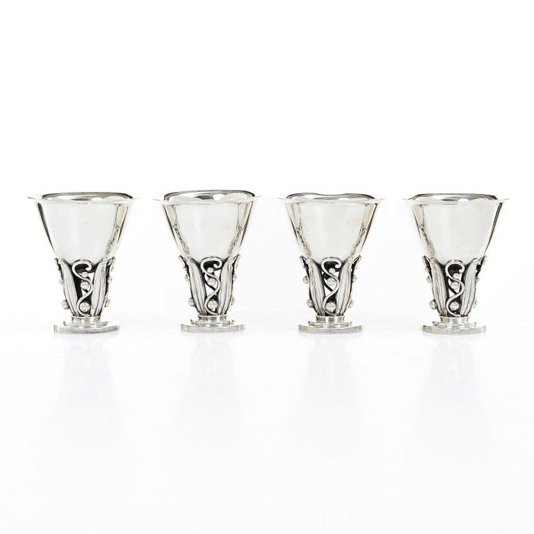 Evald Nielsen, four sterling silver beakers/cups on a foot, Denmark 20th century.