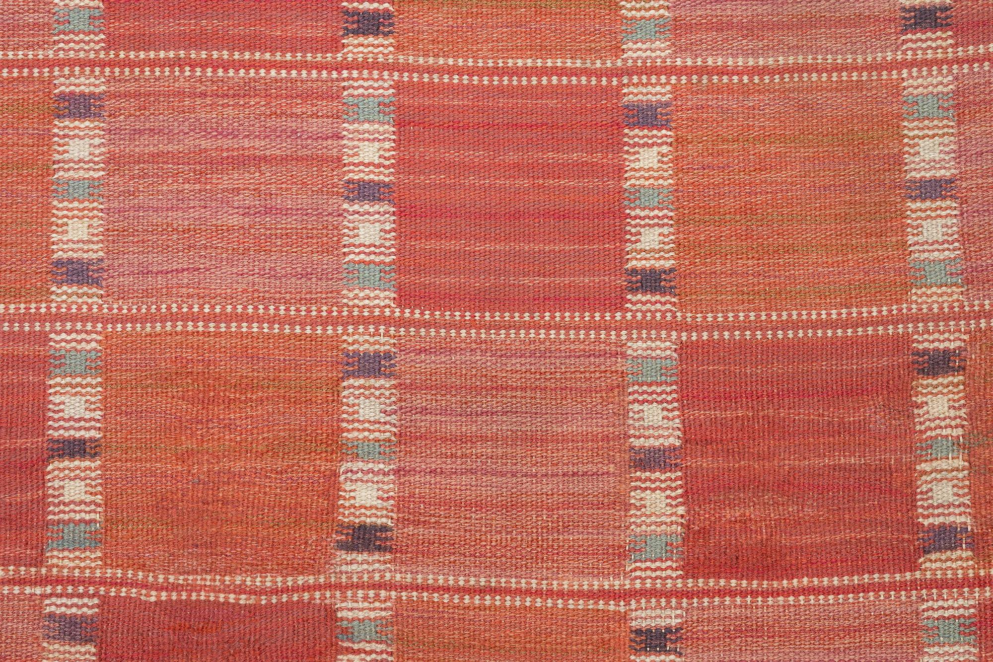 Barbro Nilsson, a carpet, 'Falurutan, röd Borås', flat weave, c. 502 x 212 cm, signed AB MMF BN.