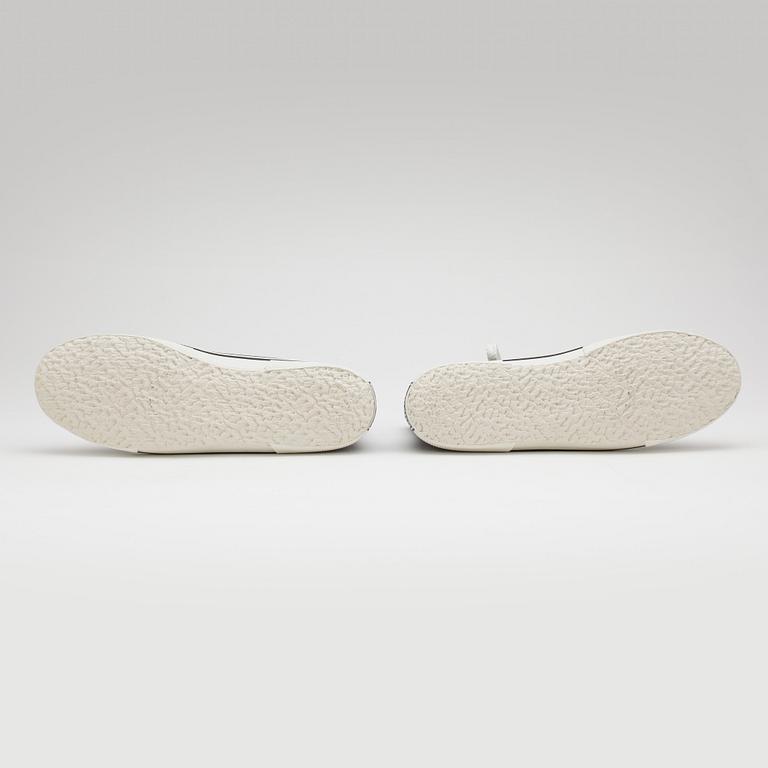 CHANEL, a pair of black canvas sneakers.