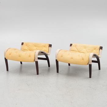 Bruno Mathsson, a pair of "Pernilla" armchair with ottoman, Dux, Sweden, second half of the 20th century.