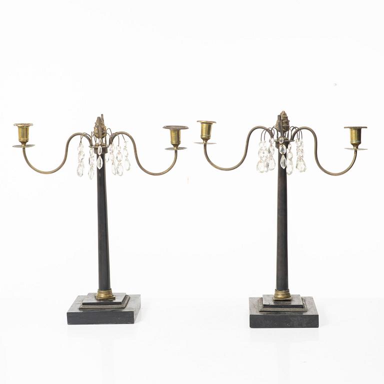 A pair of wooden candelabras, around 1900.