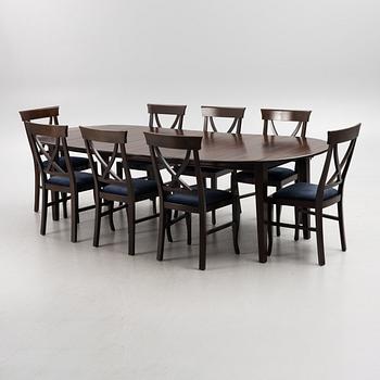 A dining table with eight chairs, Newport, around 2000.