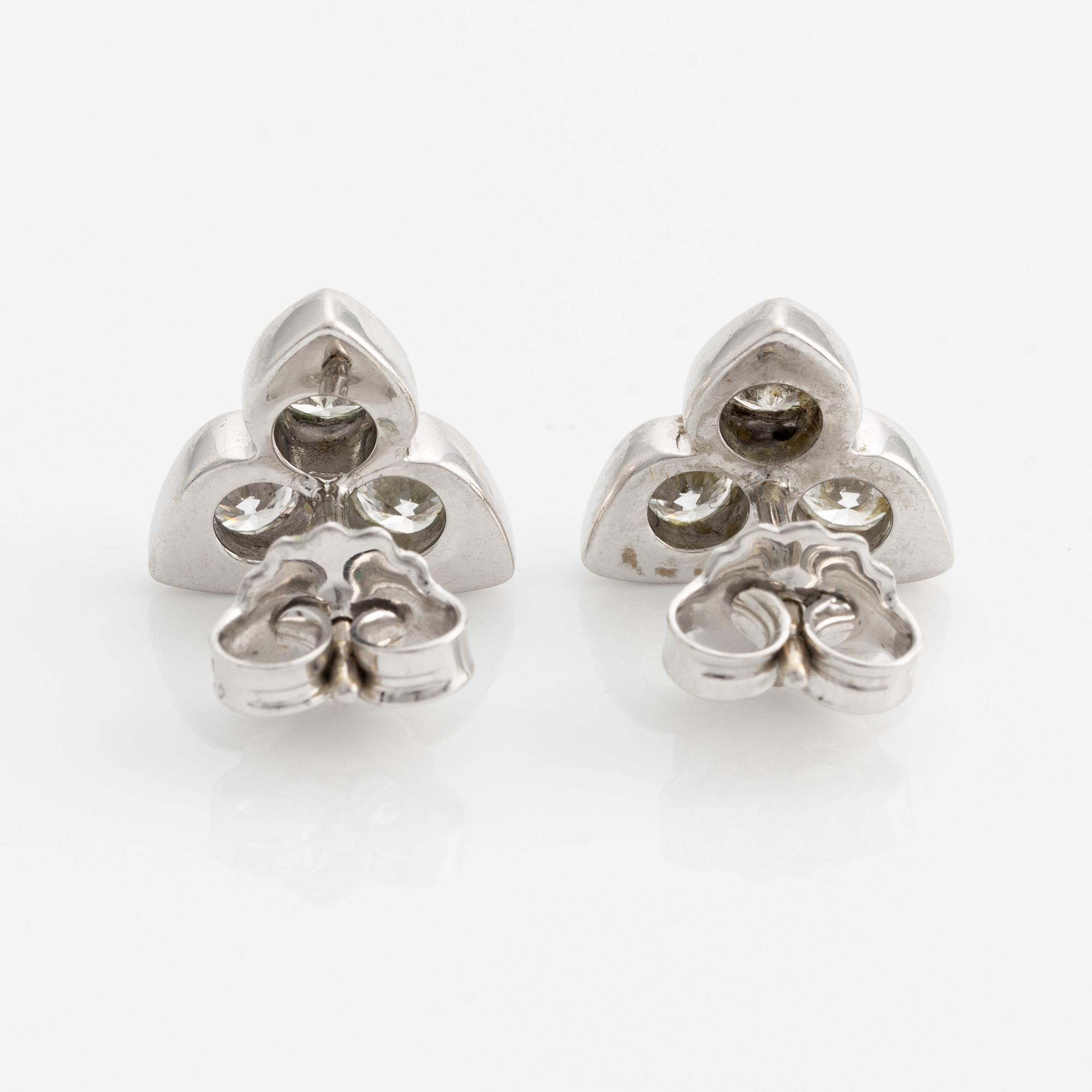 A pair of 18K white gold earrings with round brilliant-cut diamonds.