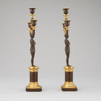 A pair of Empire early 19th century three-light candelabra.