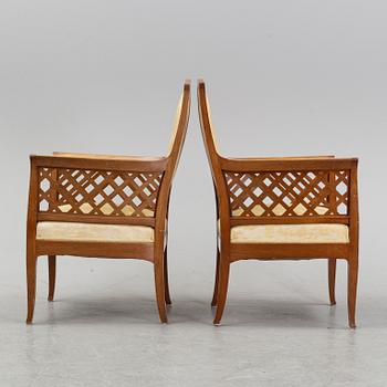 A mahogany sofa, with two armchairs and a round table, early 20th Century.