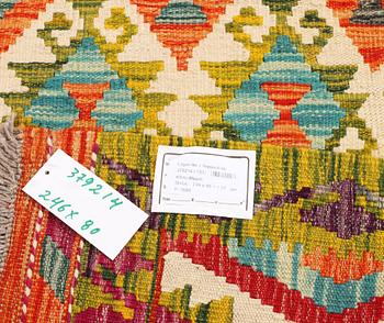 An Afghan kilim rug, c. 246 x 80 cm.