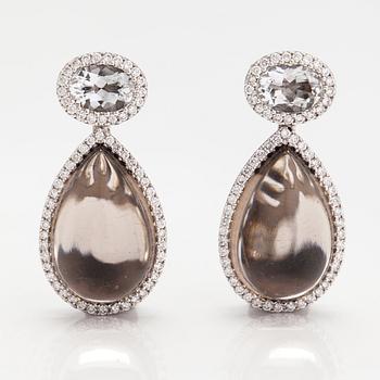 A pair of 18K white gold earrings with diamonds ca. 0.64 ct in total, smoky quartzes and topazes. Tirisi, The Netherland.