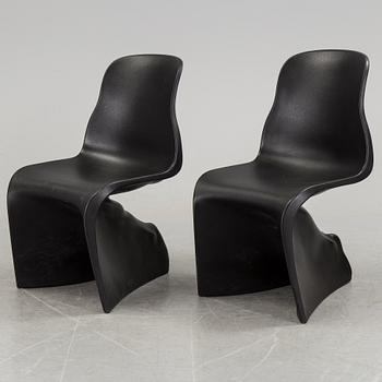 a pair of Italian black plastic chairs designed by Fabio Novembre "Him" and "Her" from the late 20th Century.