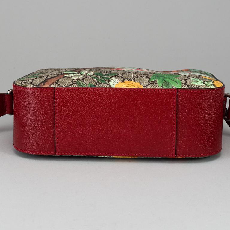 GUCCI, a patterned monogram canvas and leather bag.