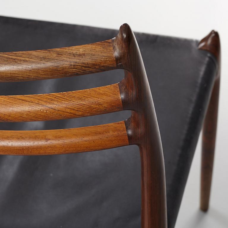 Niles Otto Møller, a rosewood veneered table with four chairs, JL Møller, Denmark, 1950's/60's.