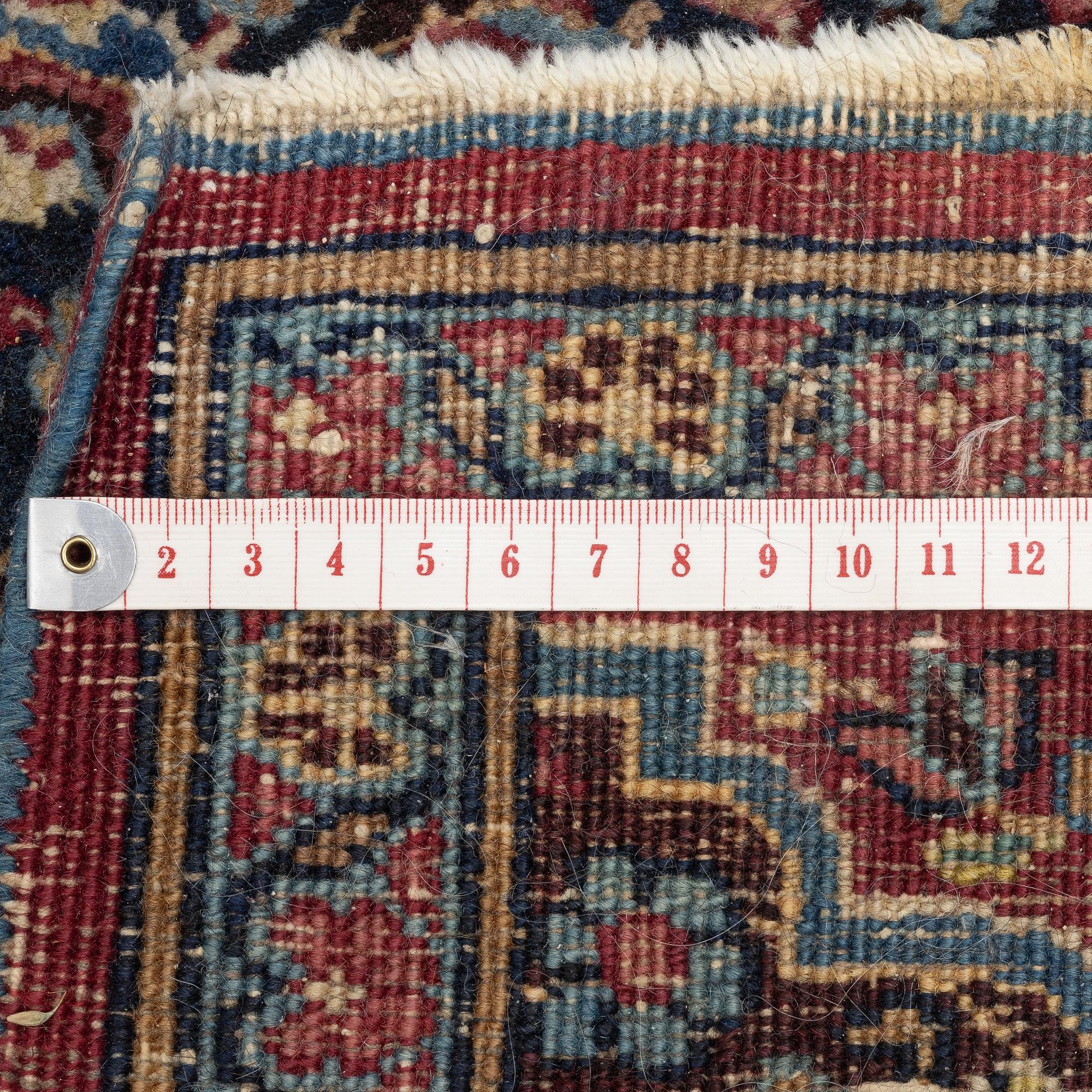 A rug, probably Meshed, semi-antique, c. 180 x 125 cm.